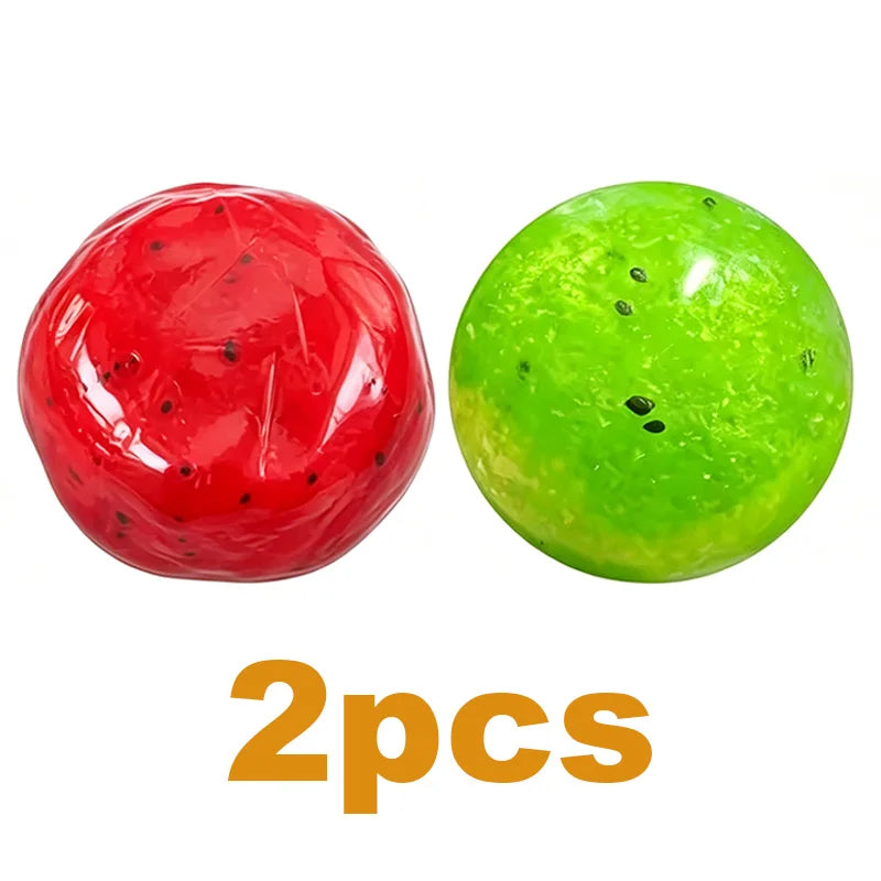 Two spherical slime squishies, one red like watermelon and one green like kiwi.