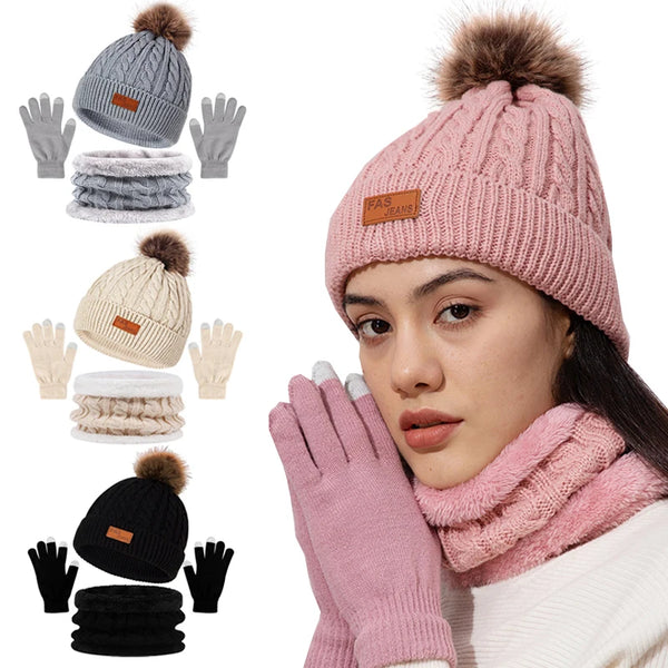 A woman models a pink knit winter hat, scarf, and gloves set with faux fur pom, showing the full product collection.