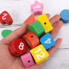 Une main tient plusieurs pièces de puzzle en bois de différentes couleurs et formes pour l'apprentissage précoce.