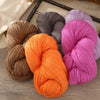 A collection of skeins of premium alpaca blend yarn in various shades including beige, gray, orange, and pink.