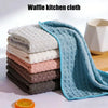 A stack of blue waffle kitchen cloths and a loose cloth are displayed on a white surface.
