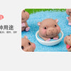 A collection of cute mini hippo resin figurines in various poses and sizes, displayed on a bright blue surface.