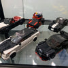 A collection of classic supercar building blocks, including a black and white sports car and a red and black race car.
