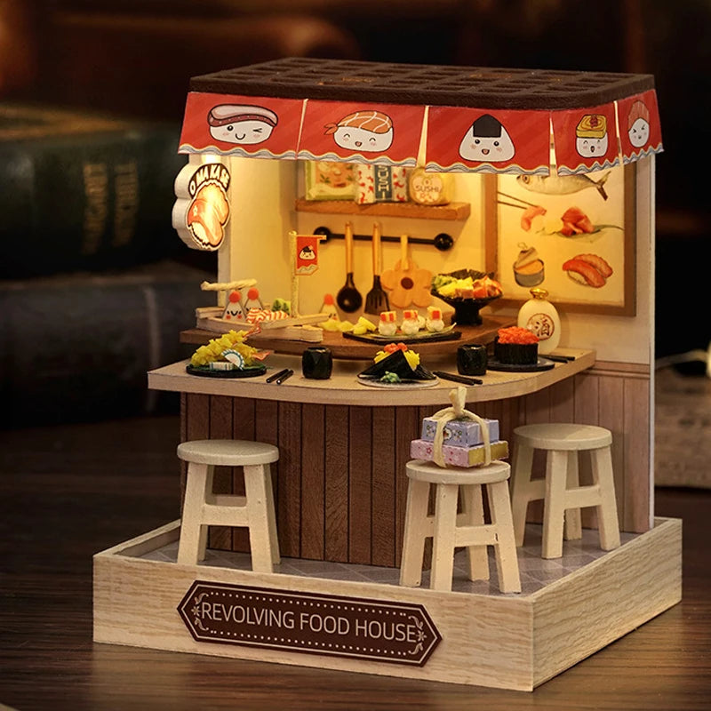 A wooden miniature food house display featuring a counter, stools, and various food items.