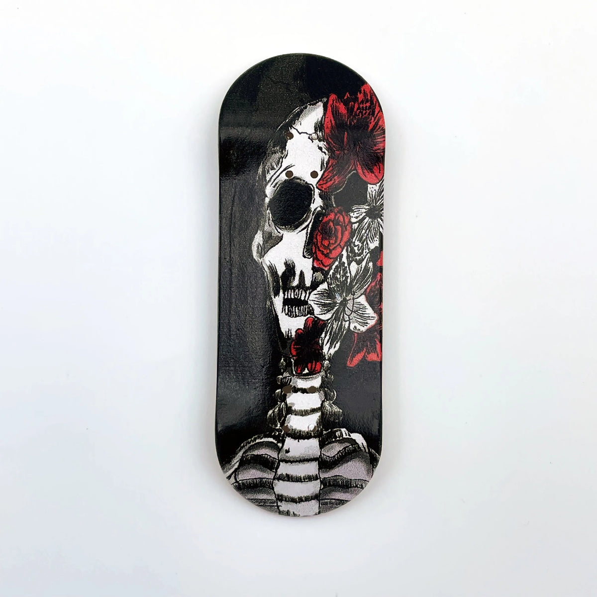 A black wooden fingerboard deck featuring a UV-printed graphic of a skull and roses.