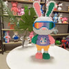 A fully assembled rabbit building block toy made of micro bricks with pink, blue, and green accents.