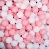 A close-up view of a large pack of pink and white colorful play balls.