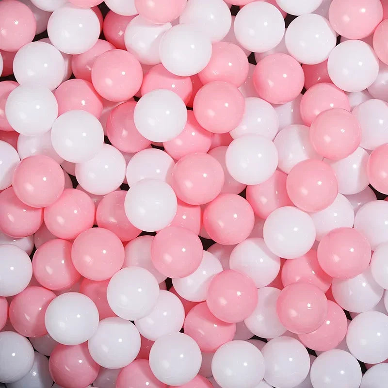 A close-up view of a large pack of pink and white colorful play balls.