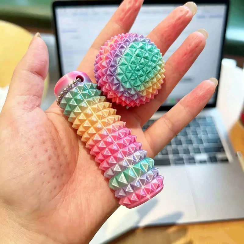 A hand holds a colorful, textured 3D printed sensory fidget roller keychain with a spiral design.