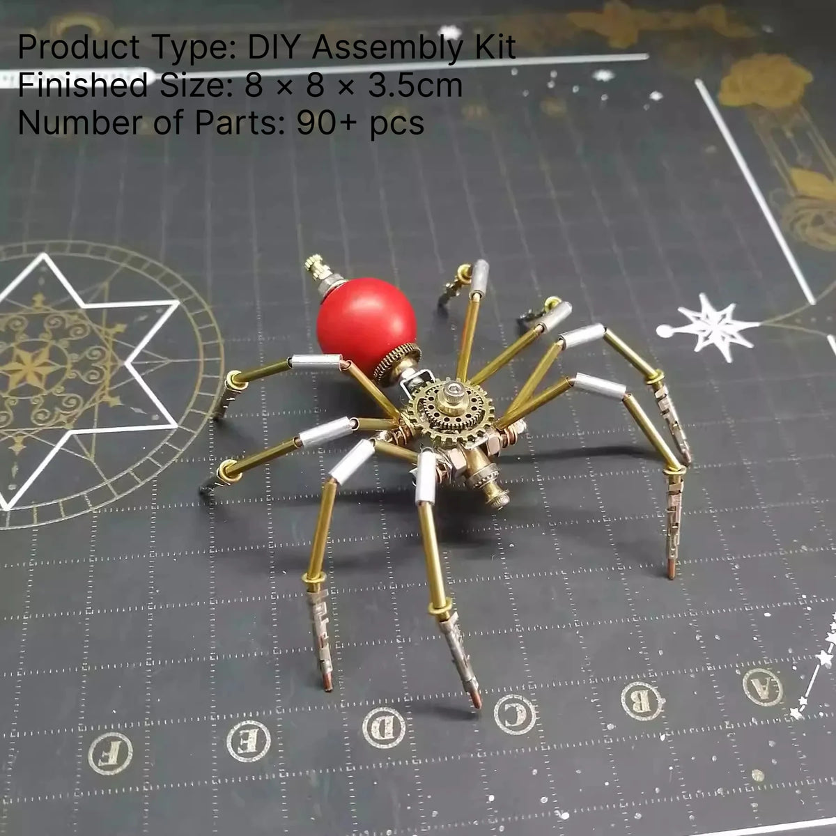 A finished steampunk metal spider assembly kit with eight spindly legs and a red body resting on a dark surface.