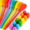 A set of colorful plastic spoons and egg-shaped scoops for a kids game