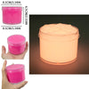 A pink glow-in-the-dark crystal slime in a clear jar, shown next to a hand and a close-up of the product.