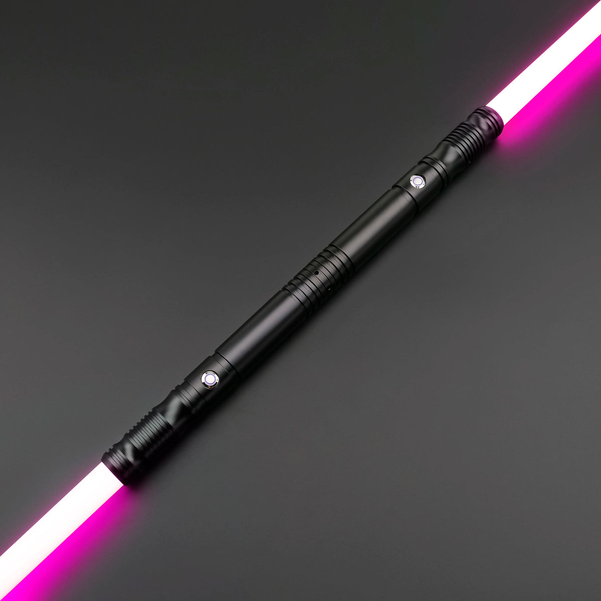 A black lightsaber staff with a glowing pink blade is shown diagonally on a dark surface.