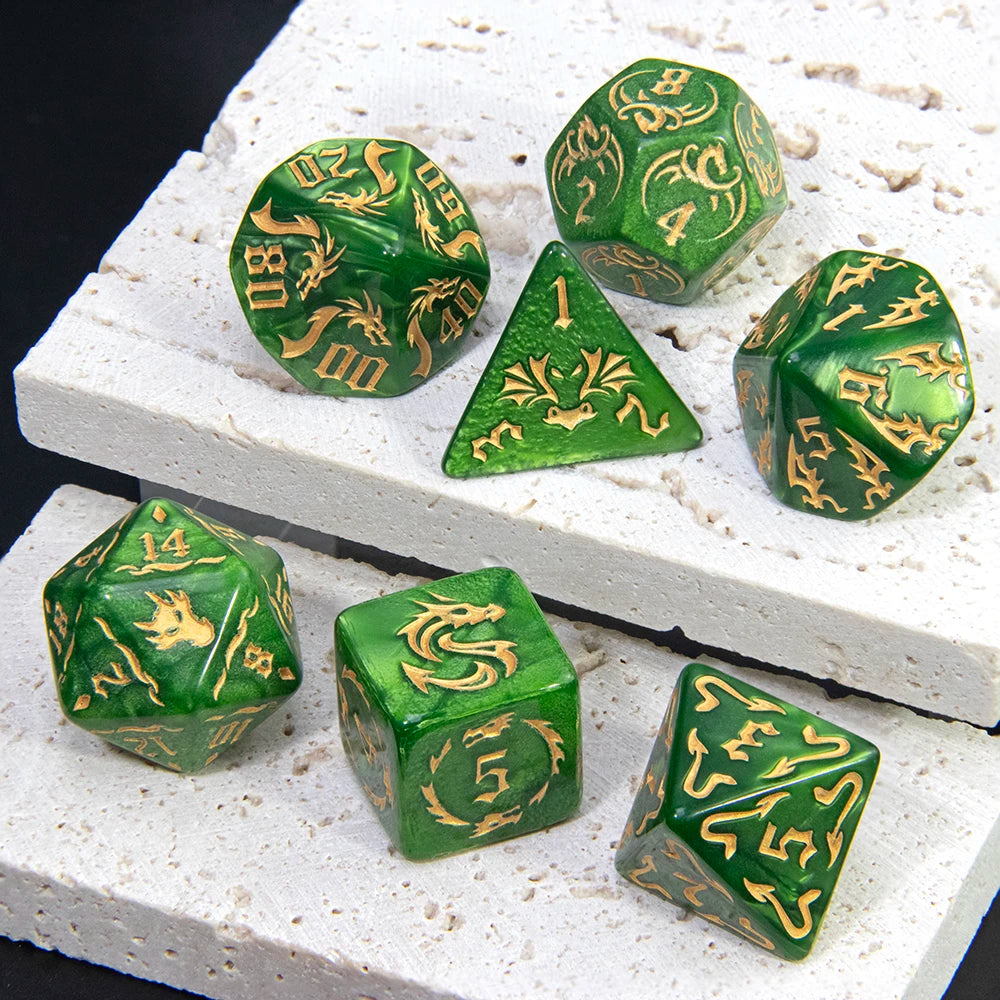 A set of green marble dragon pattern polyhedral dice resting on a white textured surface.