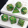 A set of green marble dragon pattern polyhedral dice resting on a white textured surface.