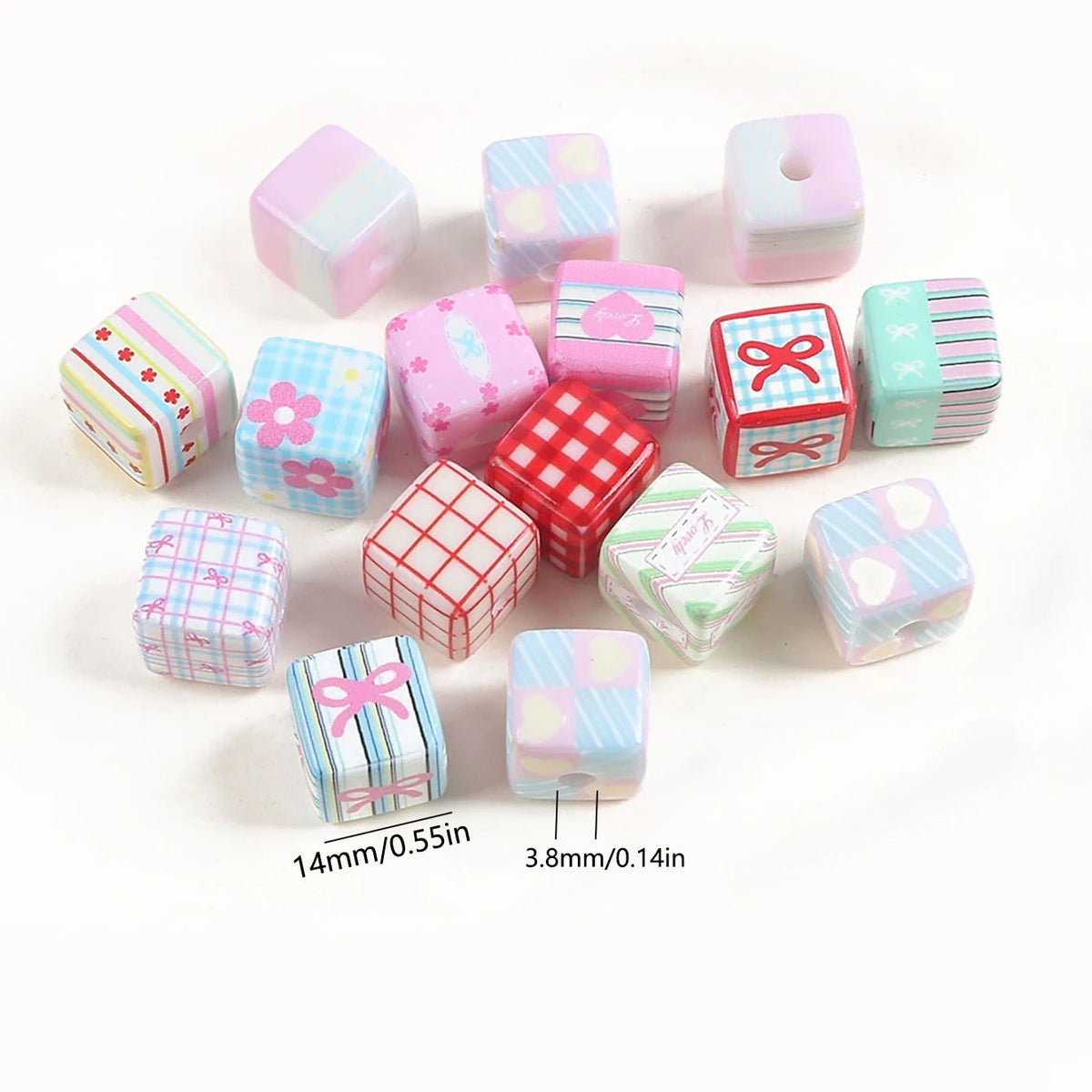 A collection of pink acrylic beads featuring various floral and patterned designs with bow charms.