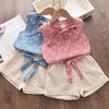 A pink floral chiffon sleeveless top and matching beige shorts set for a girl.