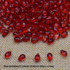 A pile of translucent red water drop Czech glass beads for jewelry making