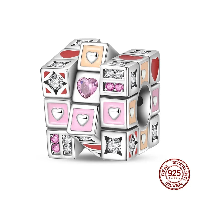 A set of colorful, heart-shaped and diamond-shaped 925 sterling silver rubik's cube charms for bracelets.