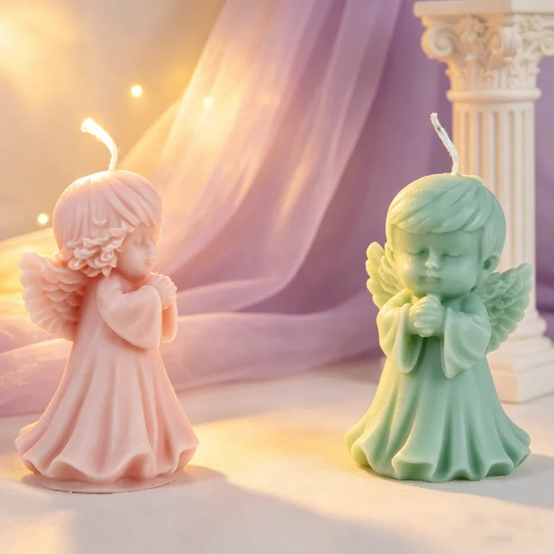 A light pink silicone mold of a praying angel figure used for making candles and resin.