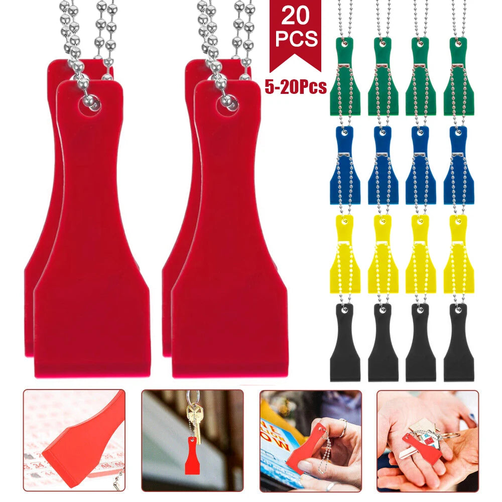 Red plastic lottery scratcher tool keychain with various colored plastic pieces and metal clasps