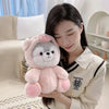 A young woman holds a pink husky plush toy against her chest in a bright indoor setting.