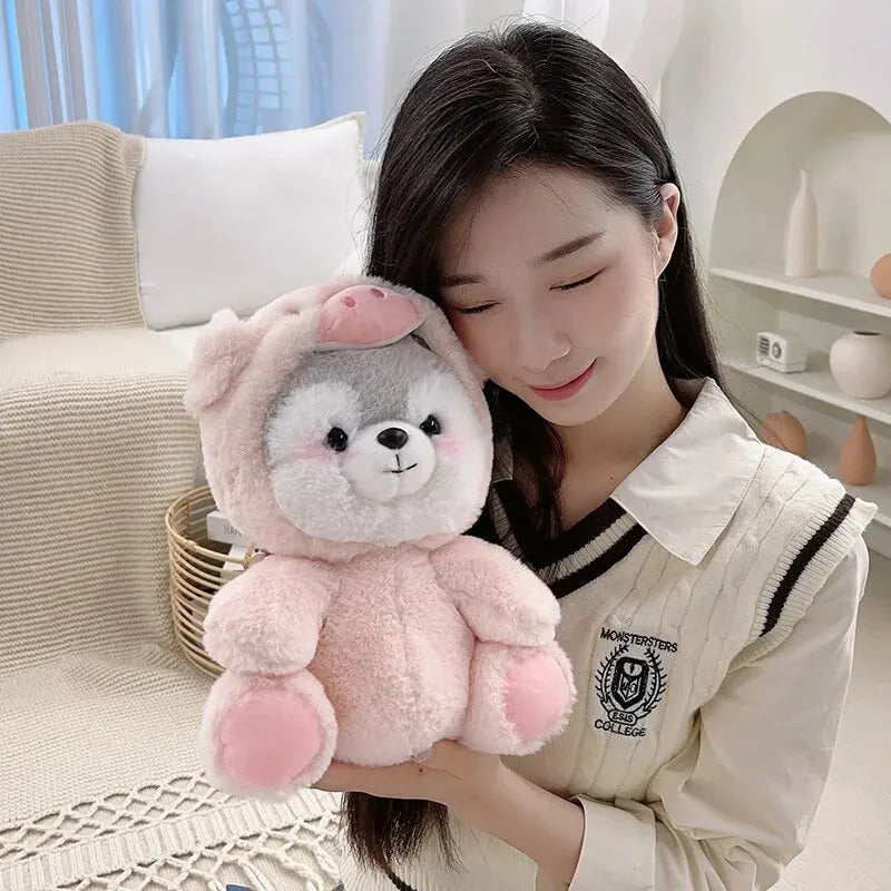 A young woman holds a pink husky plush toy against her chest in a bright indoor setting.