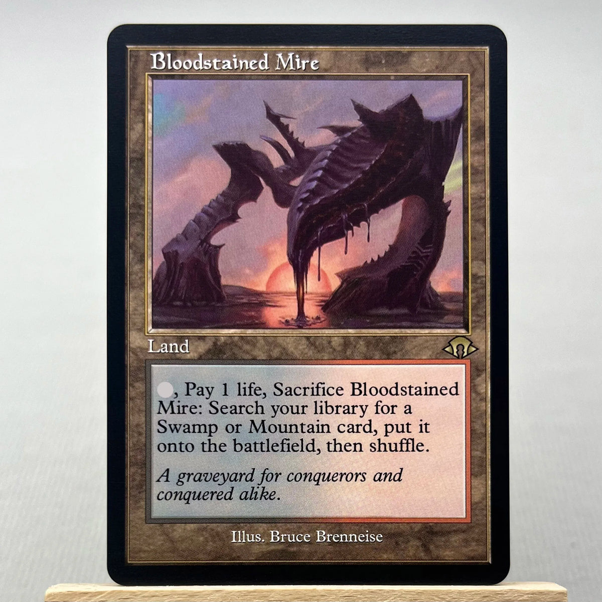 A Magic: The Gathering card named Bloodstained Mire featuring a dark swamp creature.