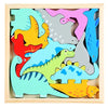 A wooden tangram puzzle board featuring colorful dinosaur shapes in various shades of green, yellow, pink, and gray.