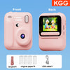 Front and back views of a pink instant print camera with accessories like a lanyard, paper, and USB cable