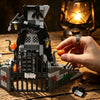 A detailed LEGO set of a spooky Halloween castle structure built from dark gray and black bricks on a wooden surface.