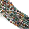A string of round loose agate beads in various shades of green, brown, and purple stones for jewelry making