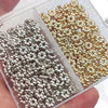A clear plastic container holds two sets of small spacer beads: silver and gold-colored, for jewelry making.
