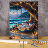 A paint by numbers kit depicting a lush flower field and wooden house landscape with hanging lights and scenic view.