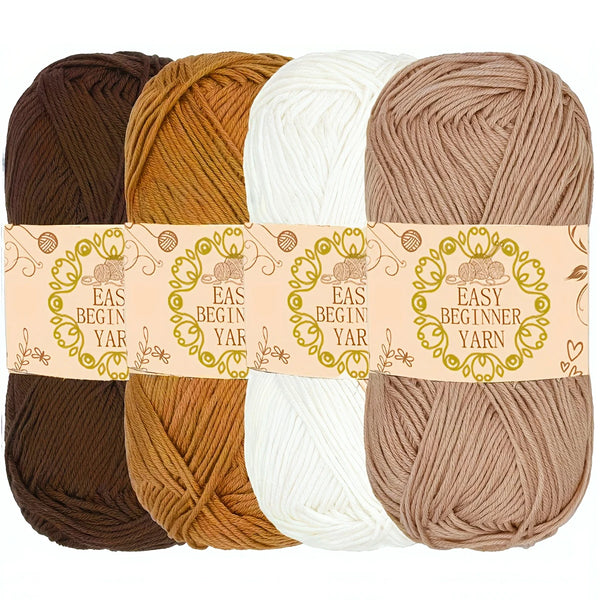 Paquete de cuatro madejas de hilo acrílico premium en tonos marrón, dorado, crema y beige.