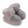 A pair of soft, gray plush baby snow boots for girls and boys.