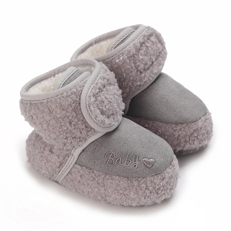 A pair of soft, gray plush baby snow boots for girls and boys.