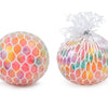 A rainbow squishy stress relief ball with colorful, translucent, squishy material tied with white netting.