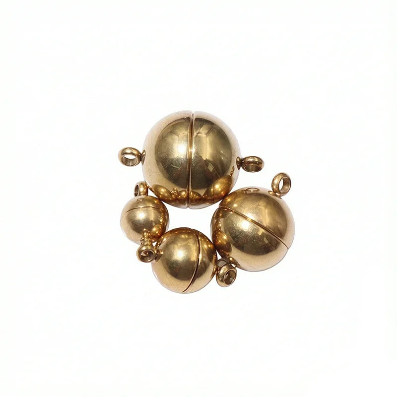 A set of gold-toned stainless steel magnetic clasps for jewelry making, featuring several spherical components.