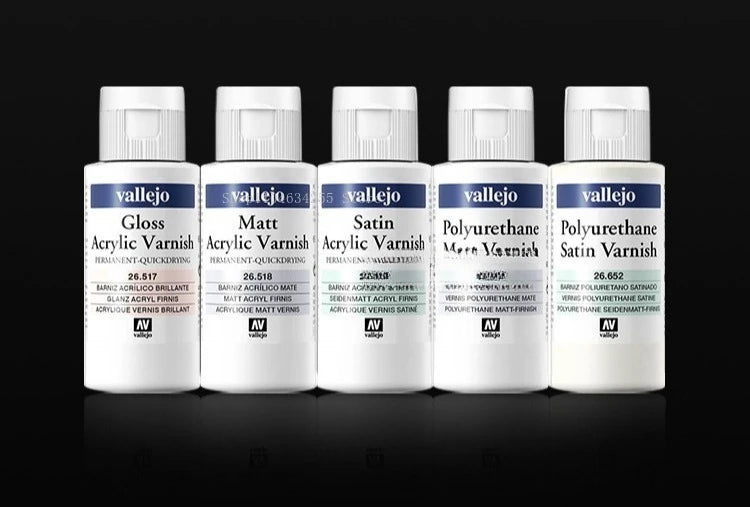 A row of nine small glass bottles of Vallejo Gloss Acrylic Varnish, Matt Acrylic Varnish, Satin Acrylic Varnish, and Polyuret