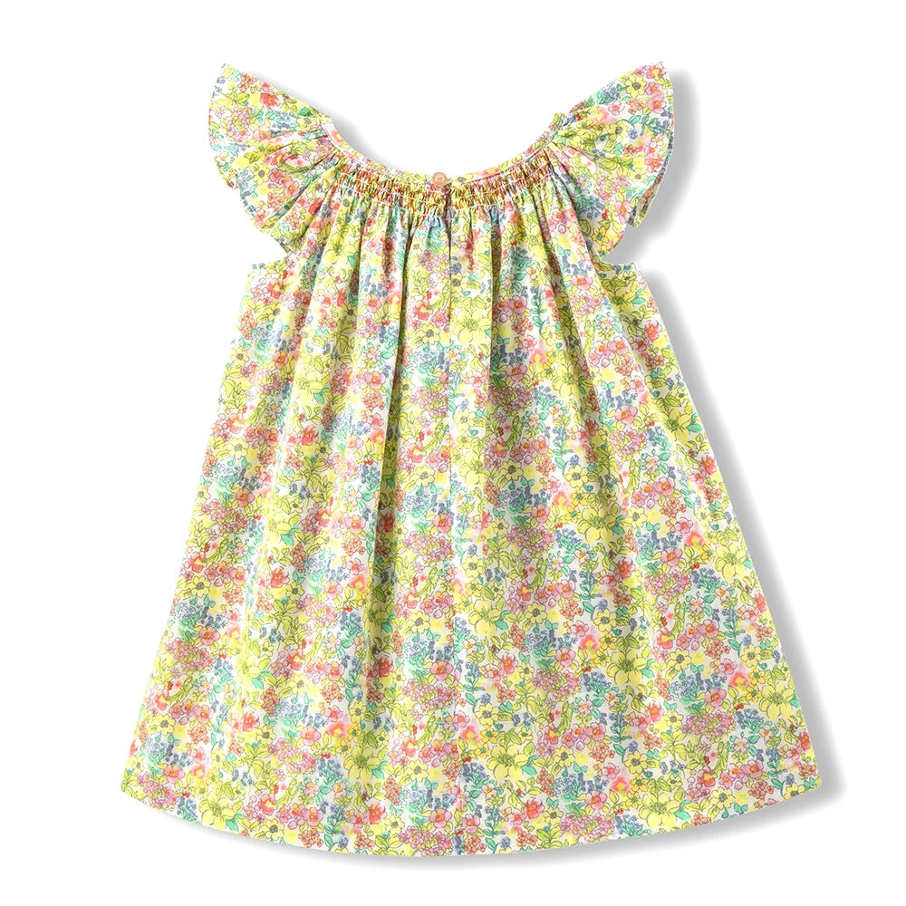 A yellow floral smocked summer dress for girls with ruffled sleeves.