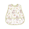 A light green baby bib featuring a watercolor pattern of gray rabbits and green foliage.