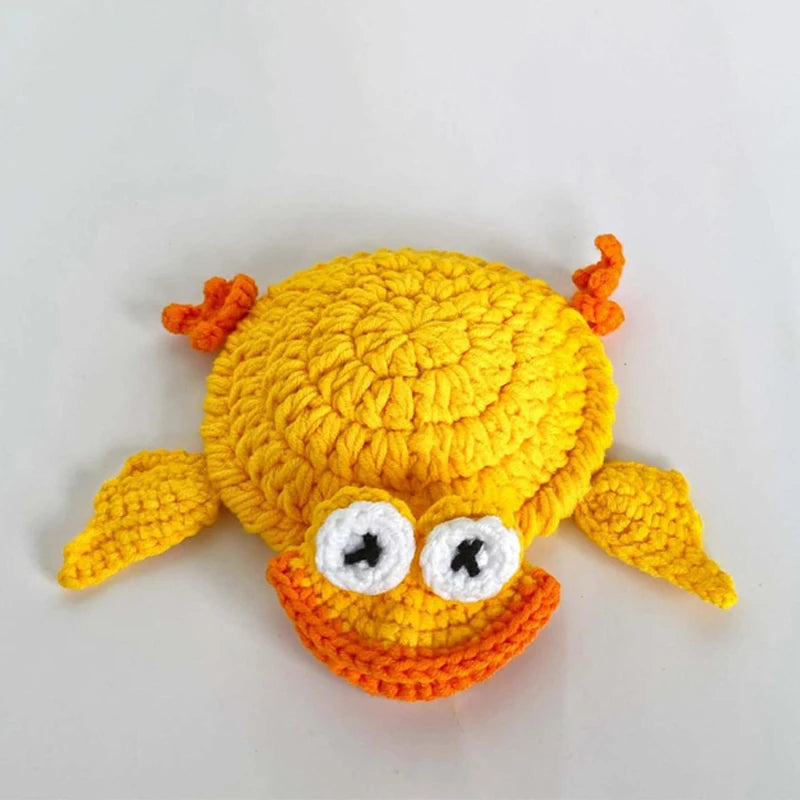 Handmade crochet lizard coaster in yellow with orange accents and large white eyes