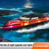 A red and black RC speedboat cutting through blue water with bright cool lights.