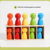 Five wooden dolls in various colors, including orange, red, yellow, green, and blue, arranged in a box.