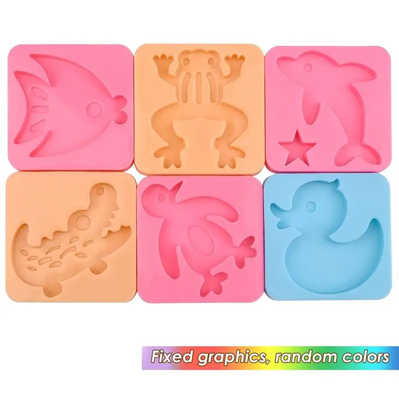 A set of five pink and orange silicone molds for DIY craft kits featuring ocean creatures like a fish, crab, dinosaur, and du