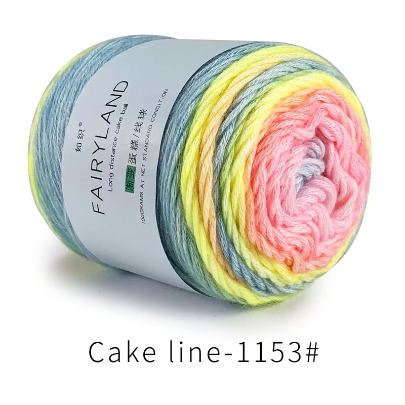 Spool of gradient rainbow cotton-wool yarn showing various pastel colors rolled up for knitting or crochet