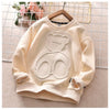 A light beige kids cartoon bear pullover sweatshirt displayed on a hanger against a grid background.
