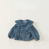 A blue denim jacket for kids featuring a ruffled collar and chest pockets.