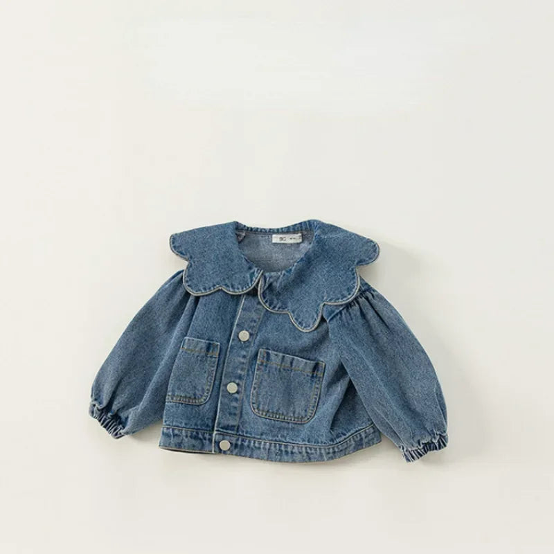 A blue denim jacket for kids featuring a ruffled collar and chest pockets.